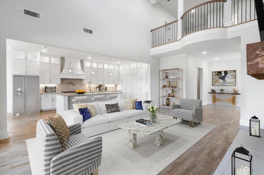 Living room featuring light hardwood / wood-style flooring and a high ceiling