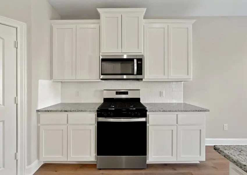 The beautiful kitchen has gorgeous white wood cabinetry. The beautiful kitchen has gorgeous white wood cabinetry.