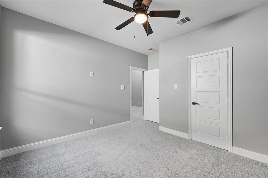 Unfurnished bedroom with carpet and ceiling fan Unfurnished bedroom with carpet and ceiling fan