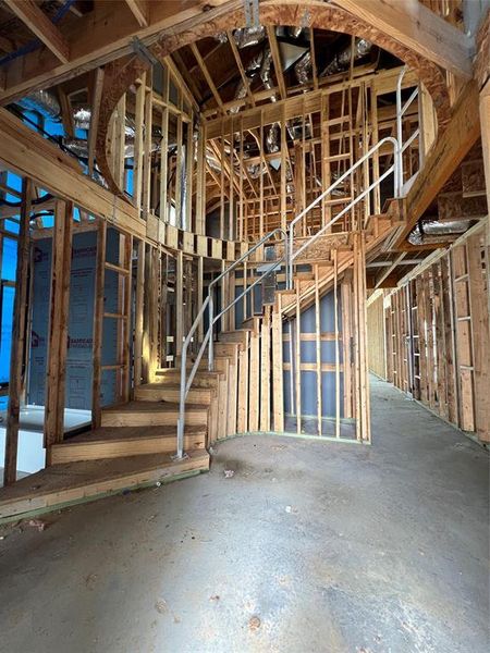 Breathtaking entrance to this castle-like home with a gorgeous spiral staircase.