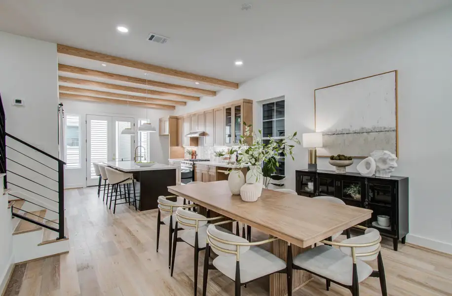 Stairs with a metal black rail and the natural wood beams add to the character of the home, modern and warm, the perfect blend!
