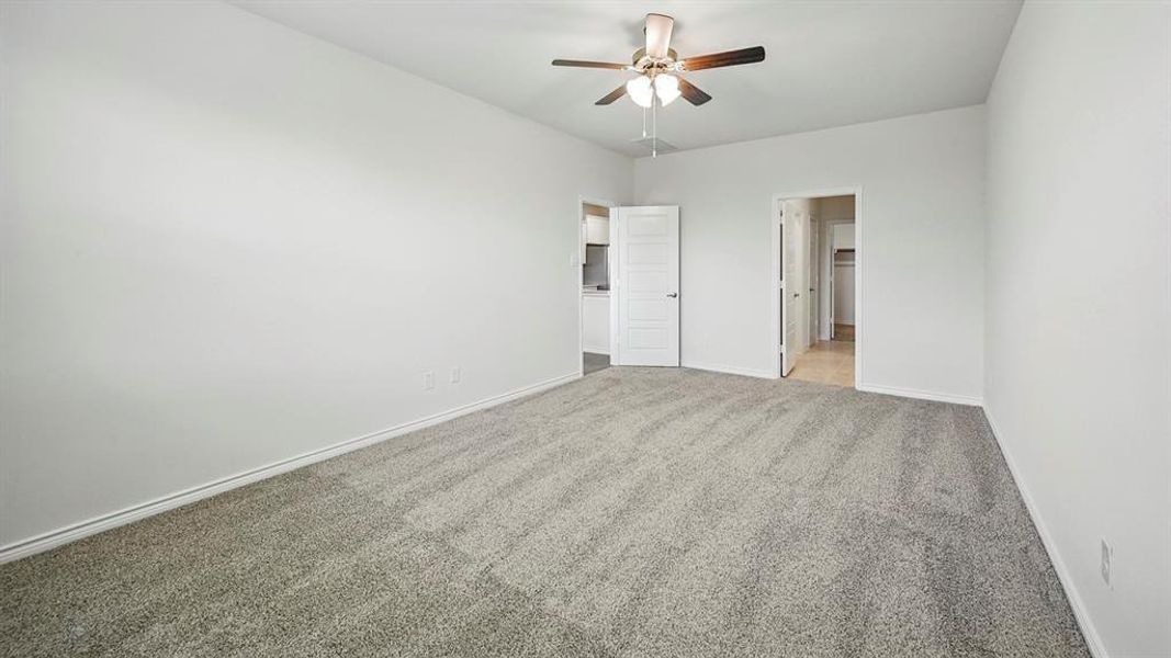 Unfurnished bedroom featuring carpet floors and ceiling fan Unfurnished bedroom featuring carpet floors and ceiling fan