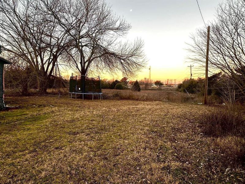 View of grassy yard featuring a trampoline View of grassy yard featuring a trampoline