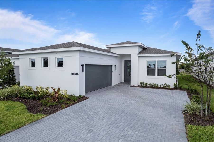 Front exterior of a new home in Cresswind at Hammock Oaks, Lady Lake, FL, highlighting curb appeal (Image 2). Front exterior of a new home in Cresswind at Hammock Oaks, Lady Lake, FL, highlighting curb appeal (Image 2).