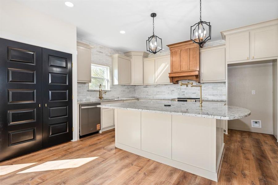 Huge serving island, custom cabinetry, Carrera marble tile wall. Huge serving island, custom cabinetry, Carrera marble tile wall.