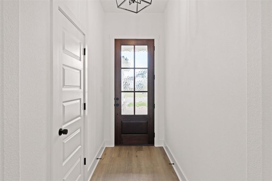 Entryway with wood finished floors and baseboards