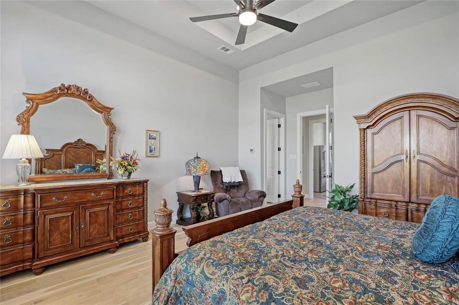 Bedroom featuring light wood finished floors and a ceiling fan Bedroom featuring light wood finished floors and a ceiling fan