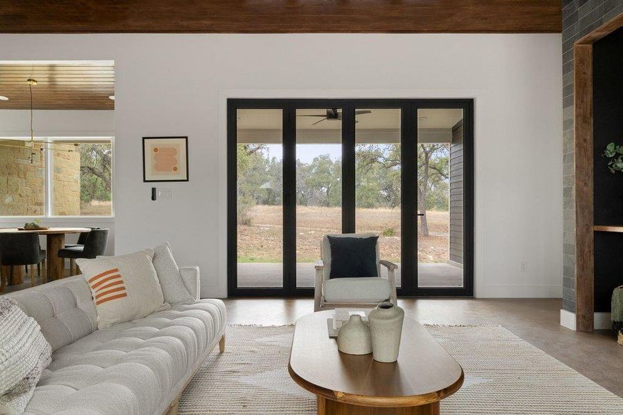 Living area with wood ceiling and finished concrete floors