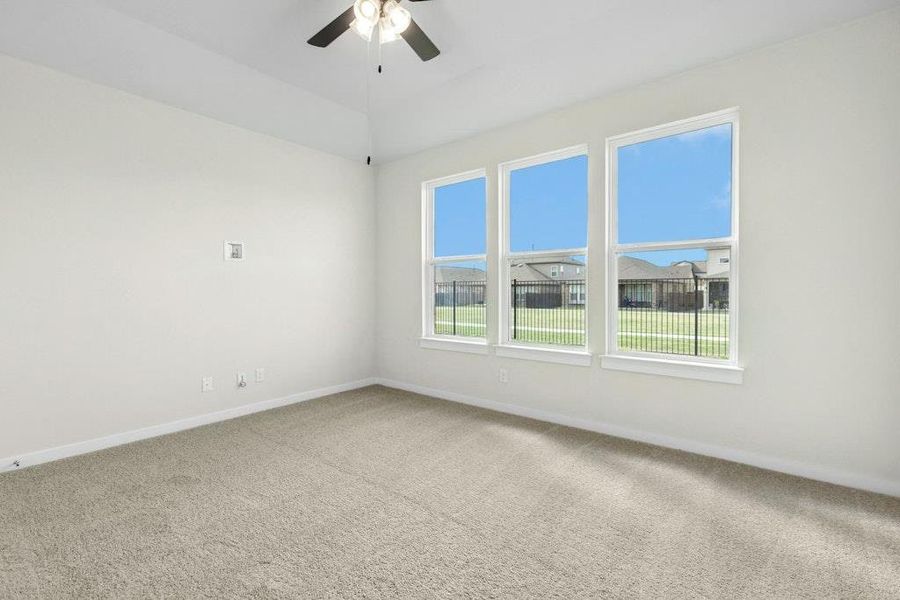 Spare room with carpet floors and a ceiling fan