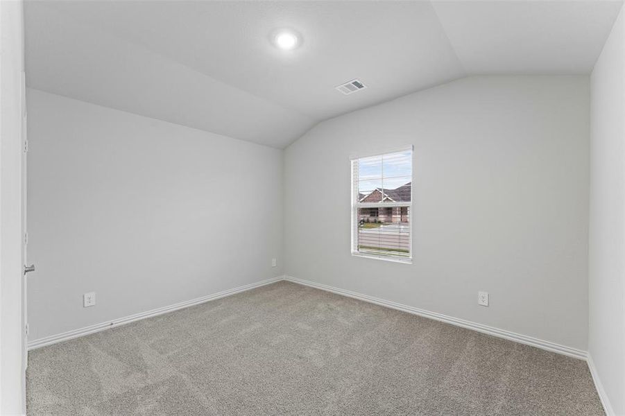 Additional living space featuring vaulted ceiling and carpet flooring Additional living space featuring vaulted ceiling and carpet flooring