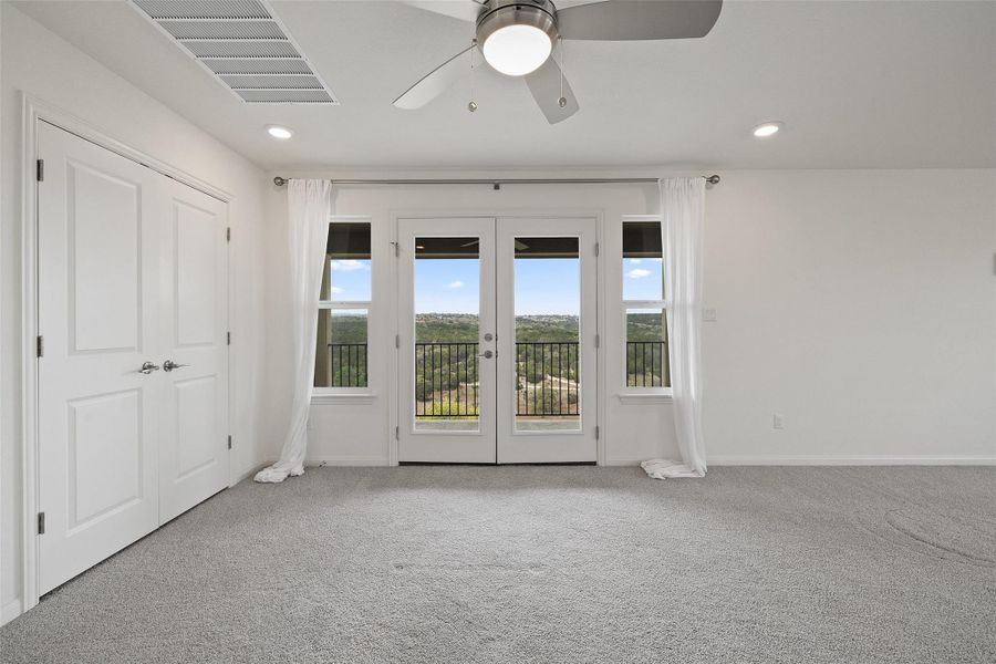 Carpeted spare room with ceiling fan, visible vents, french doors, and recessed lighting