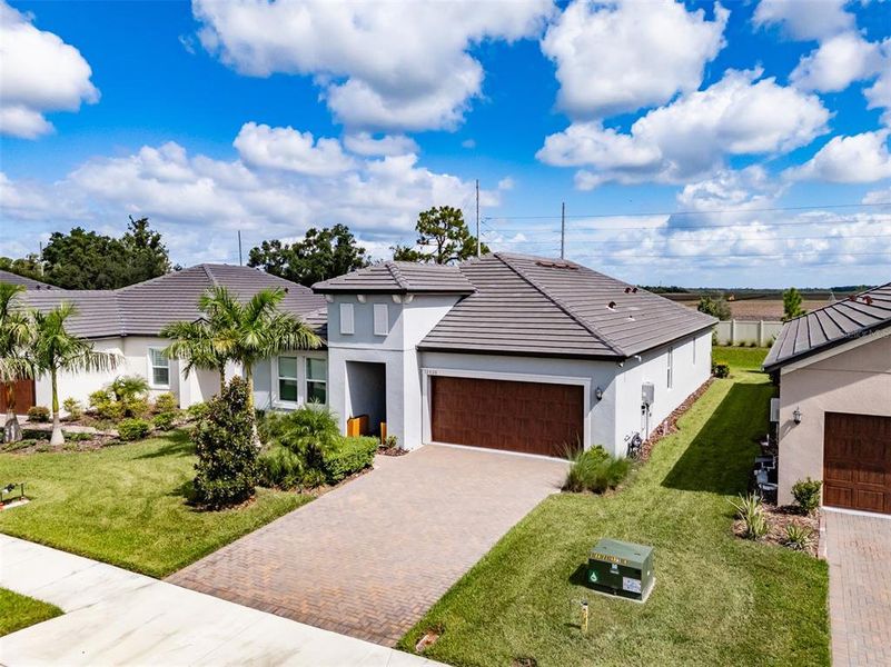 Front exterior of a new home in Prosperity Lakes, Parrish, FL, highlighting curb appeal (Image 24).