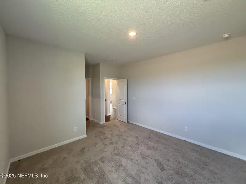 Spacious, unfurnished interior of a new home in The Cypress Series at Reserve East, Flagler Beach (Image 13).