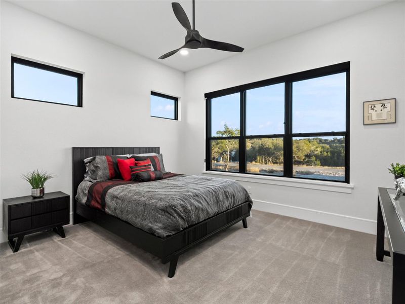 Bedroom featuring light carpet, ceiling fan, and recessed lighting