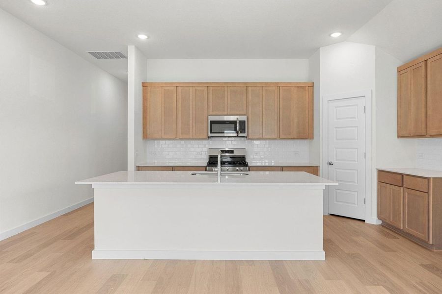 Kitchen in the Sabine home plan by Trophy Signature Homes – REPRESENTATIVE PHOTO