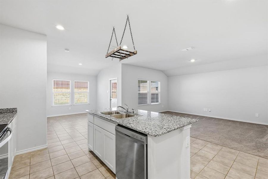 Kitchen featuring white cabinets, open floor plan, appliances with stainless steel finishes, an island with sink, and recessed lighting Kitchen featuring white cabinets, open floor plan, appliances with stainless steel finishes, an island with sink, and recessed lighting