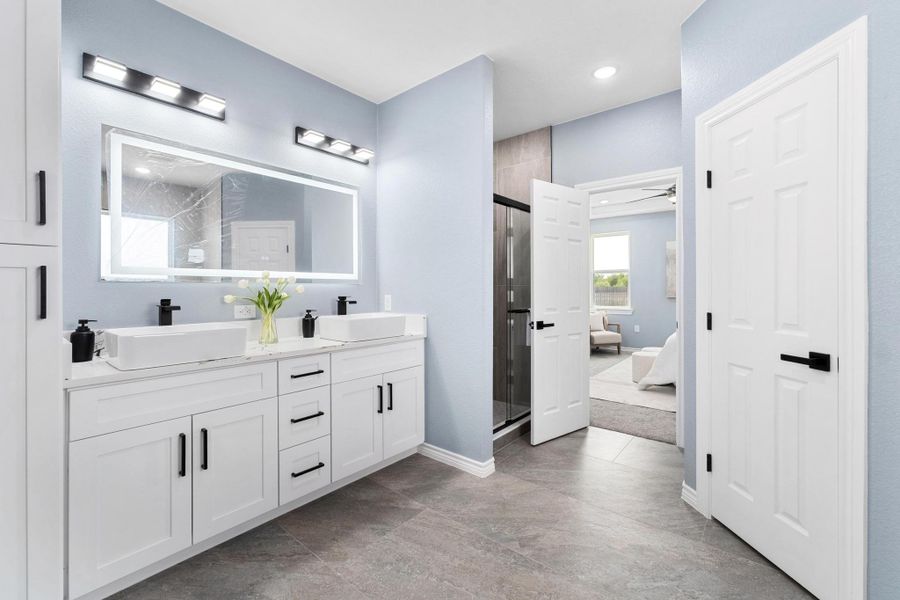 Bathroom featuring a stall shower, double vanity, ensuite bathroom, ceiling fan, and recessed lighting Bathroom featuring a stall shower, double vanity, ensuite bathroom, ceiling fan, and recessed lighting