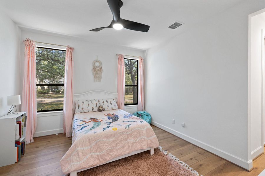 Bedroom with light wood-style floors and ceiling fan