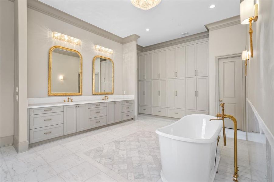 Soothe away stress in the regal soaking tub featuring an exposed tub filler and hand sprayer or the oversized walk-in shower for two outfitted with a rainfall shower head, slide bar multifunction hand sprayer and two multifunction shower heads.