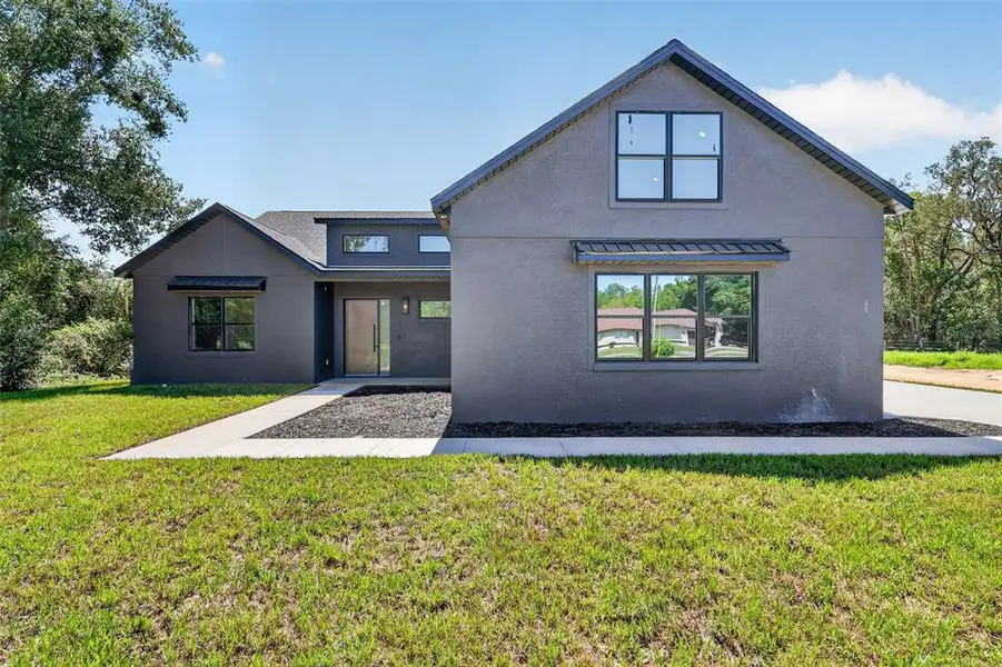 Front exterior of a new home in , Ocklawaha, FL, highlighting curb appeal (Image 28). Front exterior of a new home in , Ocklawaha, FL, highlighting curb appeal (Image 28).