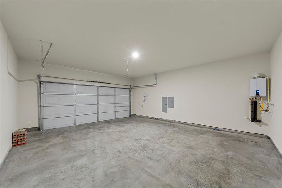 Garage with baseboards and electric panel Garage with baseboards and electric panel