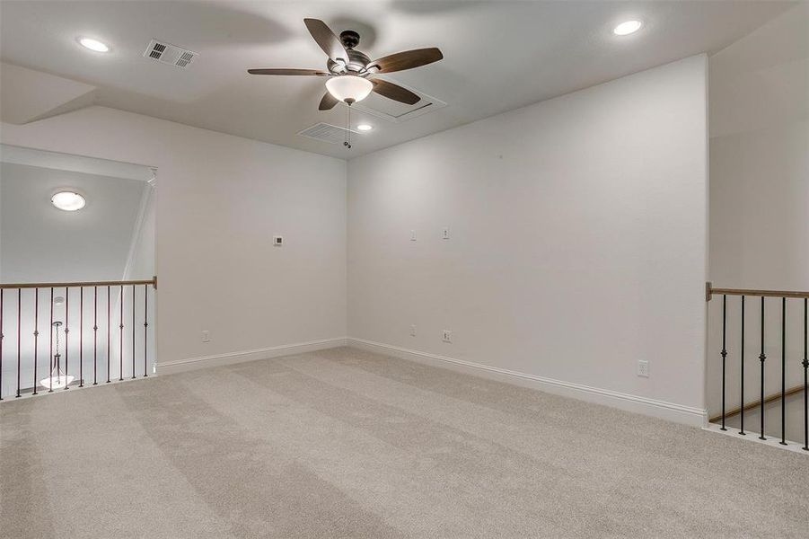 Unfurnished room featuring carpet and ceiling fan