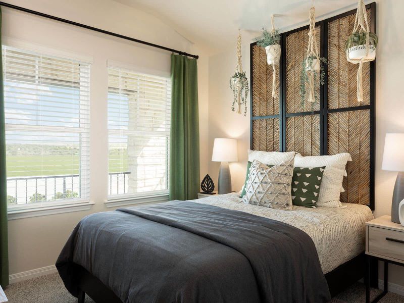 Bedroom with carpet flooring and lofted ceiling