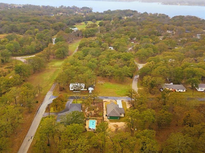 View of property location featuring a heavily wooded area and a large body of water