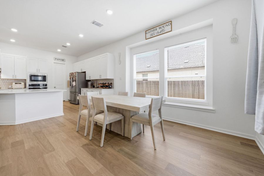 Dining area featuring light wood-type flooring and recessed lighting