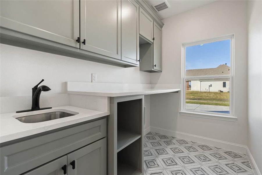 Kitchen with gray cabinetry and sink