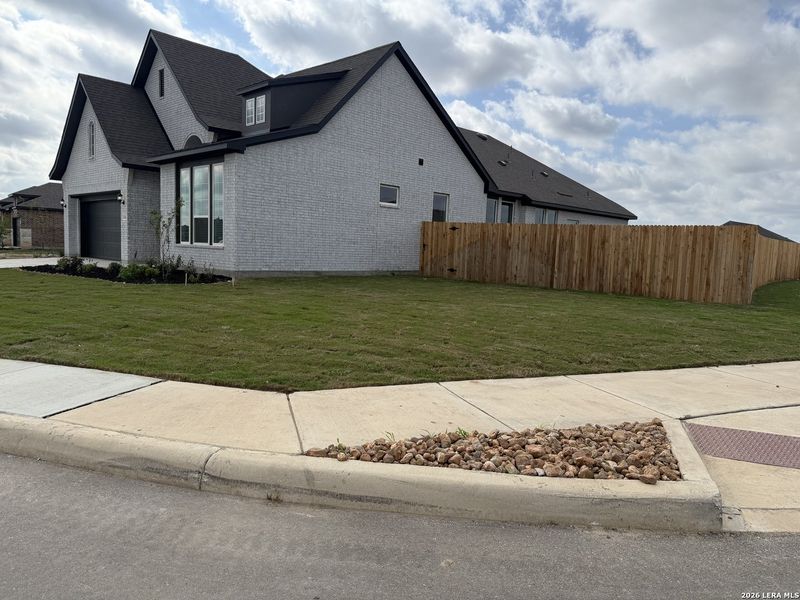 Front exterior of a new home in Alsatian Oaks, Castroville, TX, highlighting curb appeal (Image 2). Front exterior of a new home in Alsatian Oaks, Castroville, TX, highlighting curb appeal (Image 2).