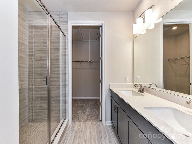 En Suite Primary Bath with Modern Tiled Walk-In Shower.