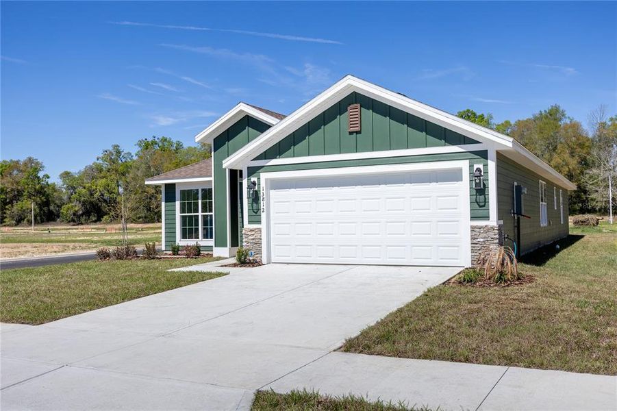 Front exterior of a new home in Briarwood, Alachua, FL, highlighting curb appeal (Image 16).