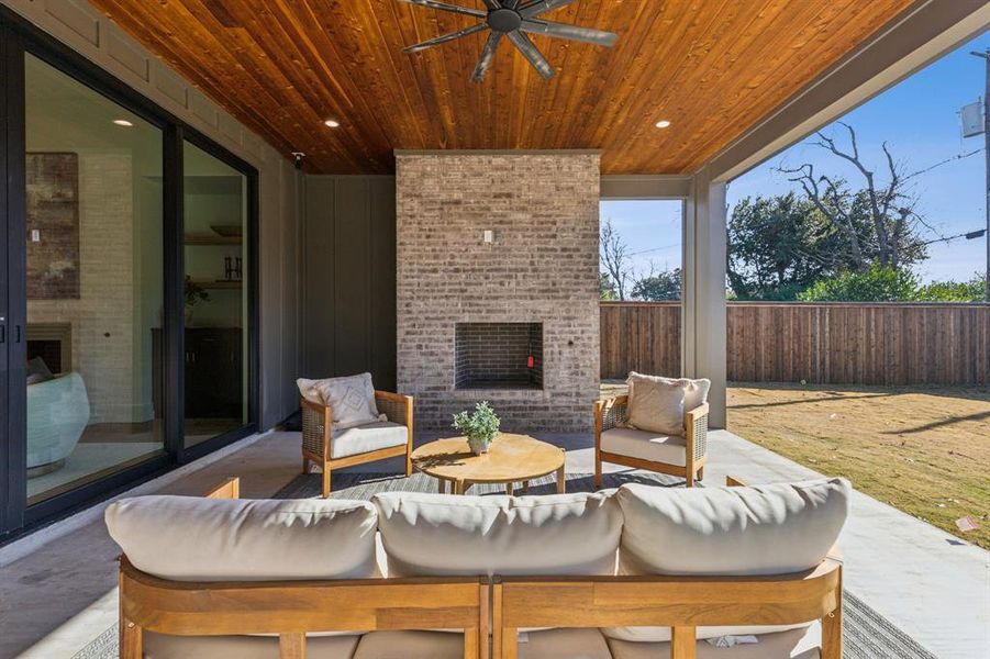 View of patio featuring an outdoor living space with a fireplace and ceiling fan