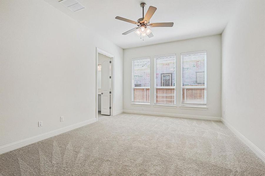 Empty room featuring ceiling fan and light colored carpet