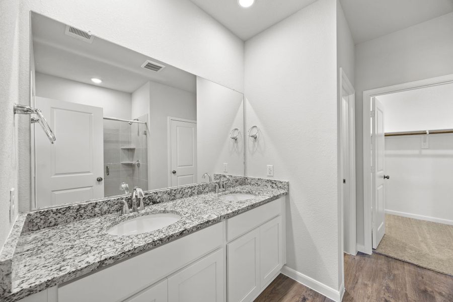 A bathroom with a large mirror.