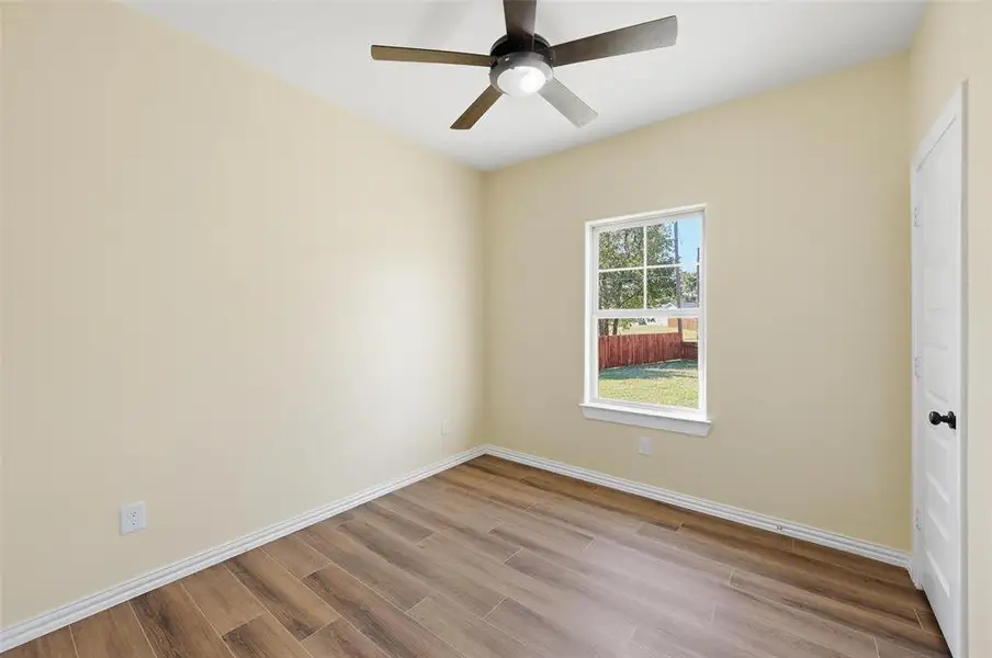 Spare room with light wood-style floors and a ceiling fan Spare room with light wood-style floors and a ceiling fan