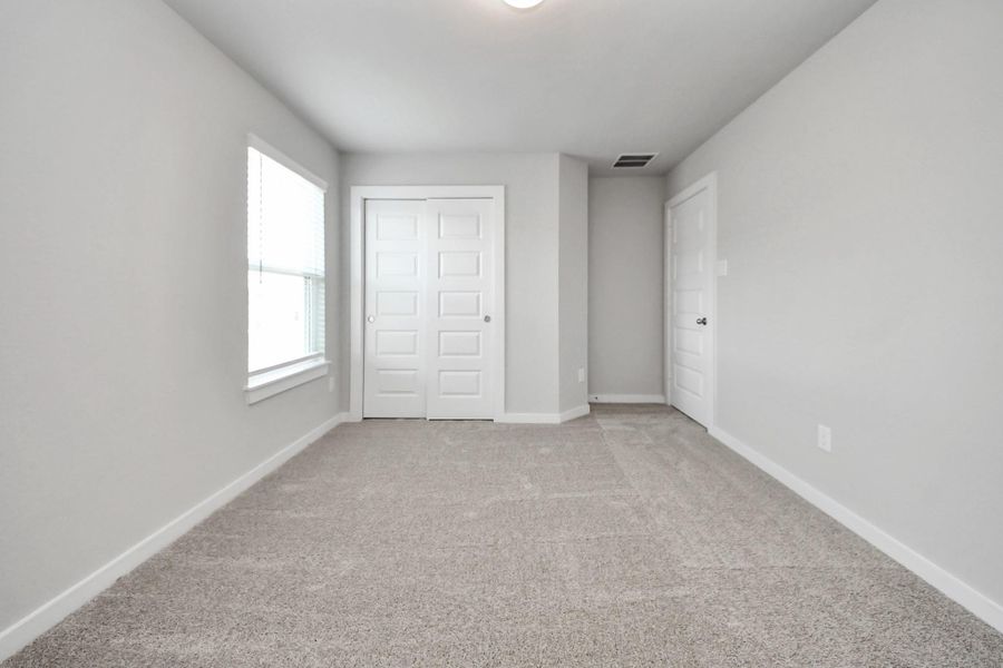 Generously sized secondary bedrooms featuring spacious closets, soft and inviting carpeting underfoot, large windows allowing plenty of natural light, and the added touch of privacy blinds for your personal retreat. Sample photo of completed home with similar floor plan. Actual colors and selections may vary. Generously sized secondary bedrooms featuring spacious closets, soft and inviting carpeting underfoot, large windows allowing plenty of natural light, and the added touch of privacy blinds for your personal retreat. Sample photo of completed home with similar floor plan. Actual colors and selections may vary.