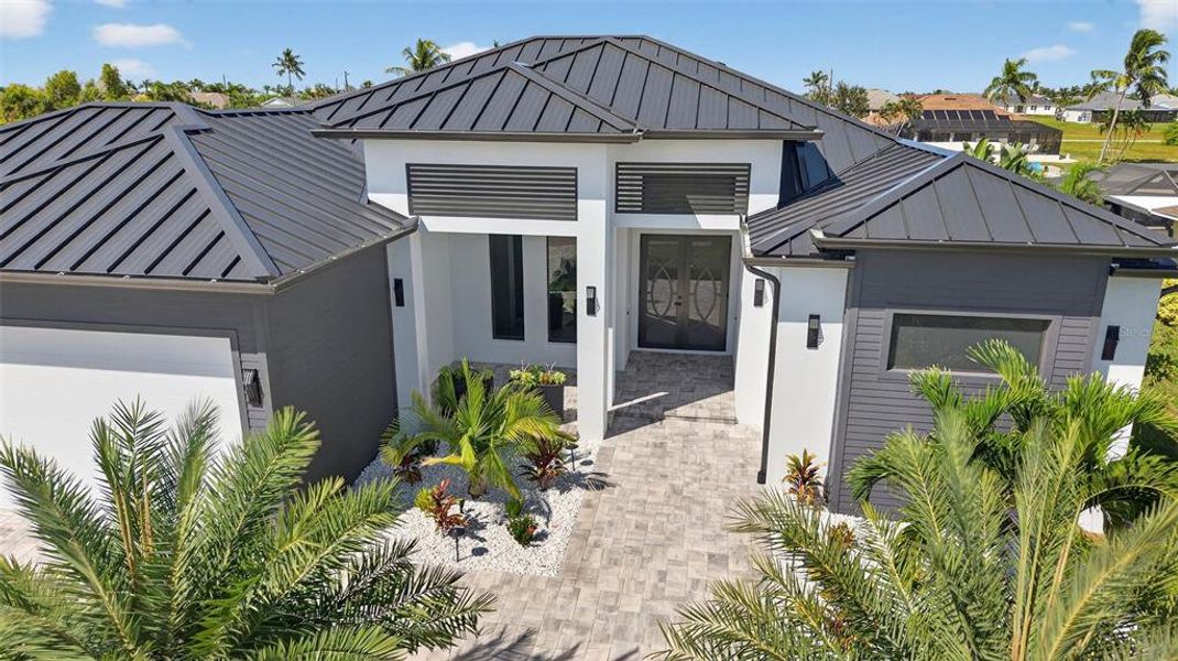 Front exterior of a new home in , Cape Coral, FL, highlighting curb appeal (Image 1). Front exterior of a new home in , Cape Coral, FL, highlighting curb appeal (Image 1).