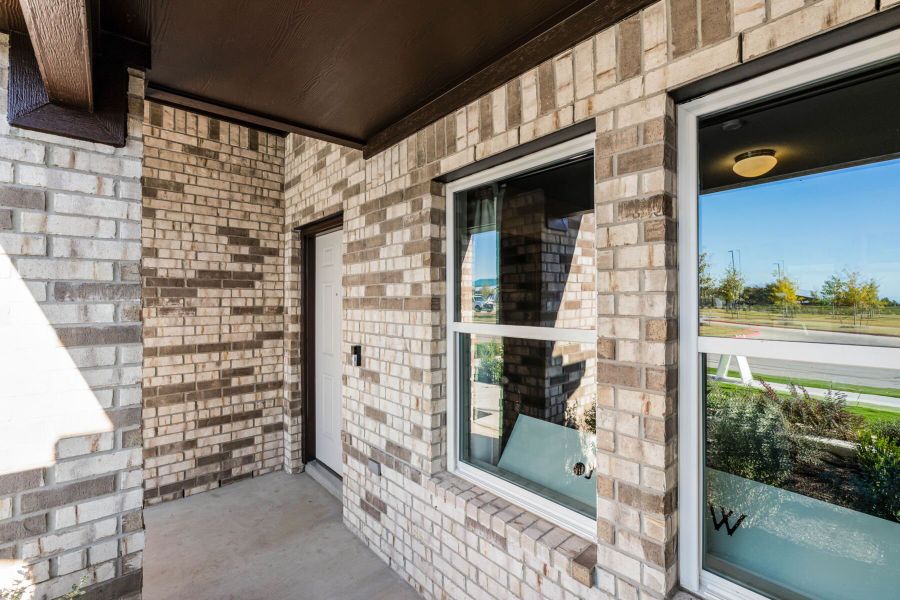 This is the front exterior of the Hawkins plan. This is the model home located in Carillon at 13305 Eppright Trace Blvd., Manor, TX This is the front exterior of the Hawkins plan. This is the model home located in Carillon at 13305 Eppright Trace Blvd., Manor, TX