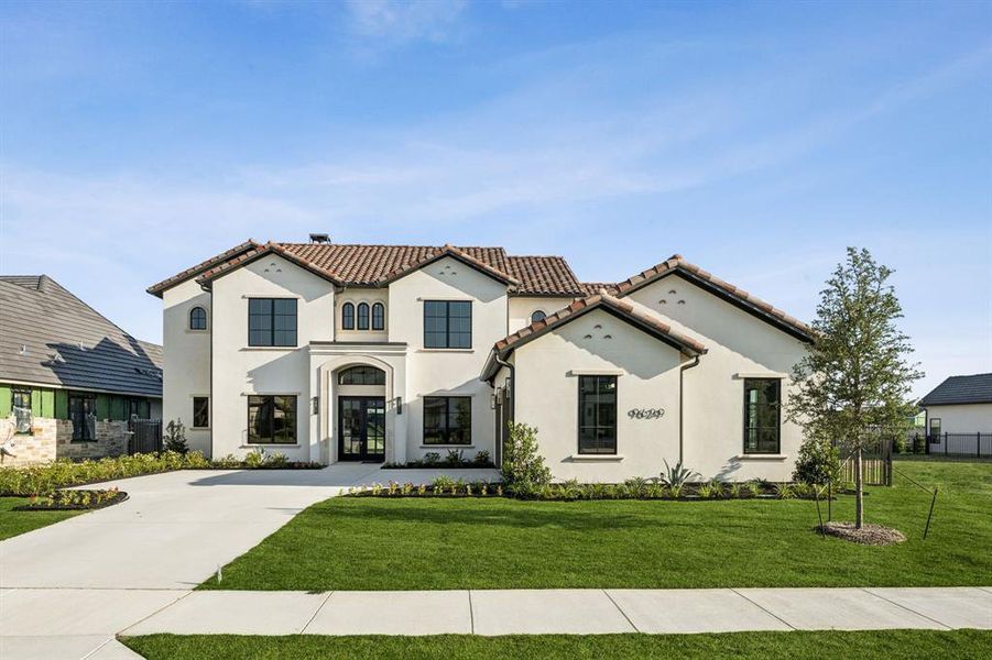 Mediterranean / spanish-style house with stucco siding, a tiled roof, french doors, and driveway Mediterranean / spanish-style house with stucco siding, a tiled roof, french doors, and driveway