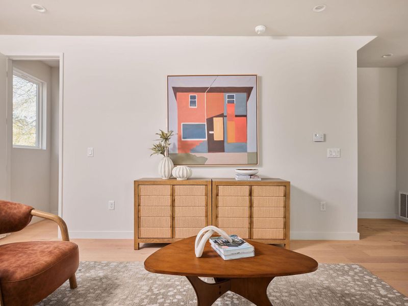 Living area with healthy amount of natural light, french doors, and wood finished floors