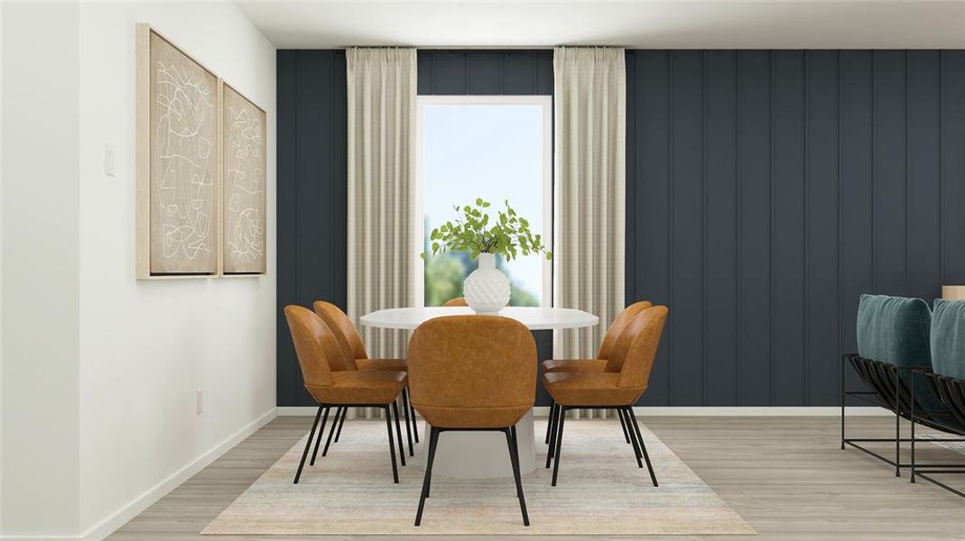 Dining space featuring light wood-style flooring and baseboards