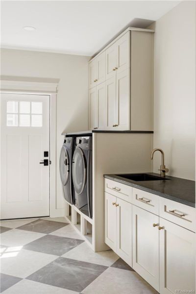 Spacious laundry room with custom cabinetry and ample storage