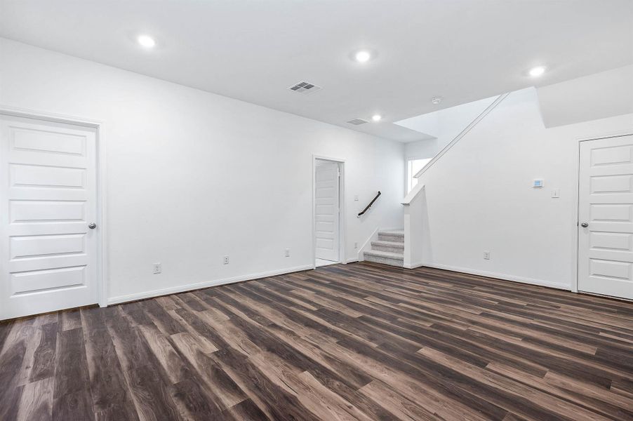 Spacious versatile family room, first floor, with a staircase leading to the 2nd. Spacious versatile family room, first floor, with a staircase leading to the 2nd.