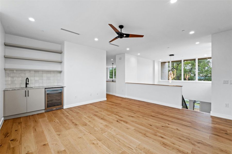 Upstairs den with beverage cooler and wet bar, strategically located adjacent to the minor bedroom wing. Teen center, kids play area, intimate family time on movie night. Perhaps add a pool table?