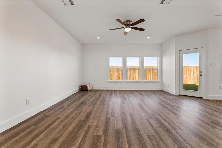 living room with dark hardwood / wood-style floors and ceiling fan