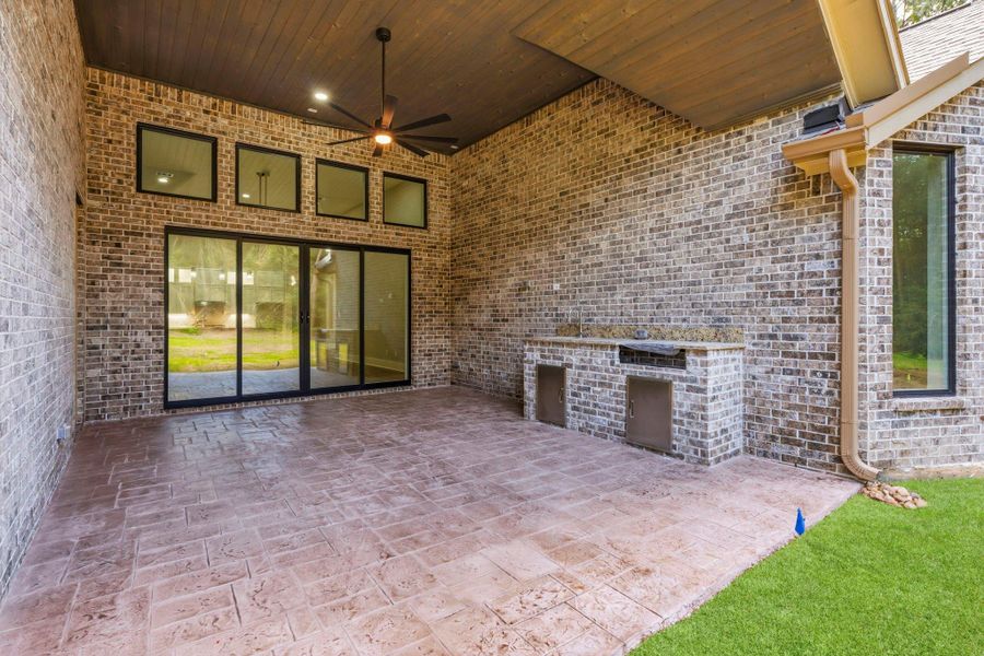 Covered patio with tongue and groove ceiling, pre-wired for TV and stamped flooring.