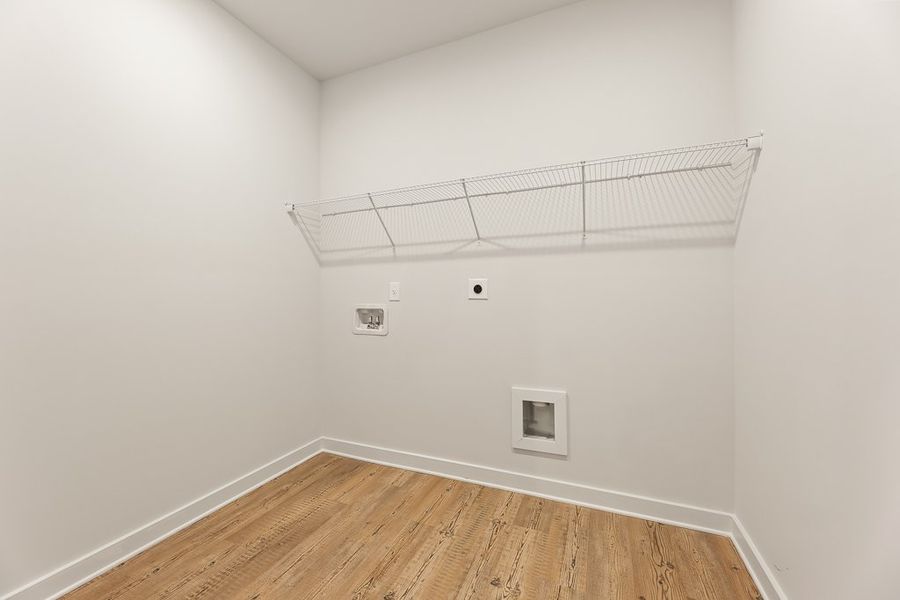 A room with a wood floor and a metal railing.