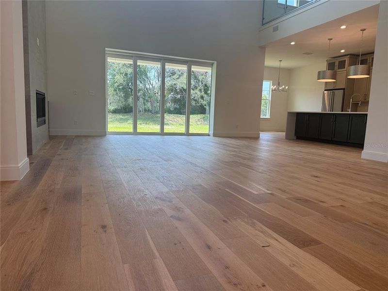 Great Room with sliders to Lanai opening to kitchen & breakfast nook